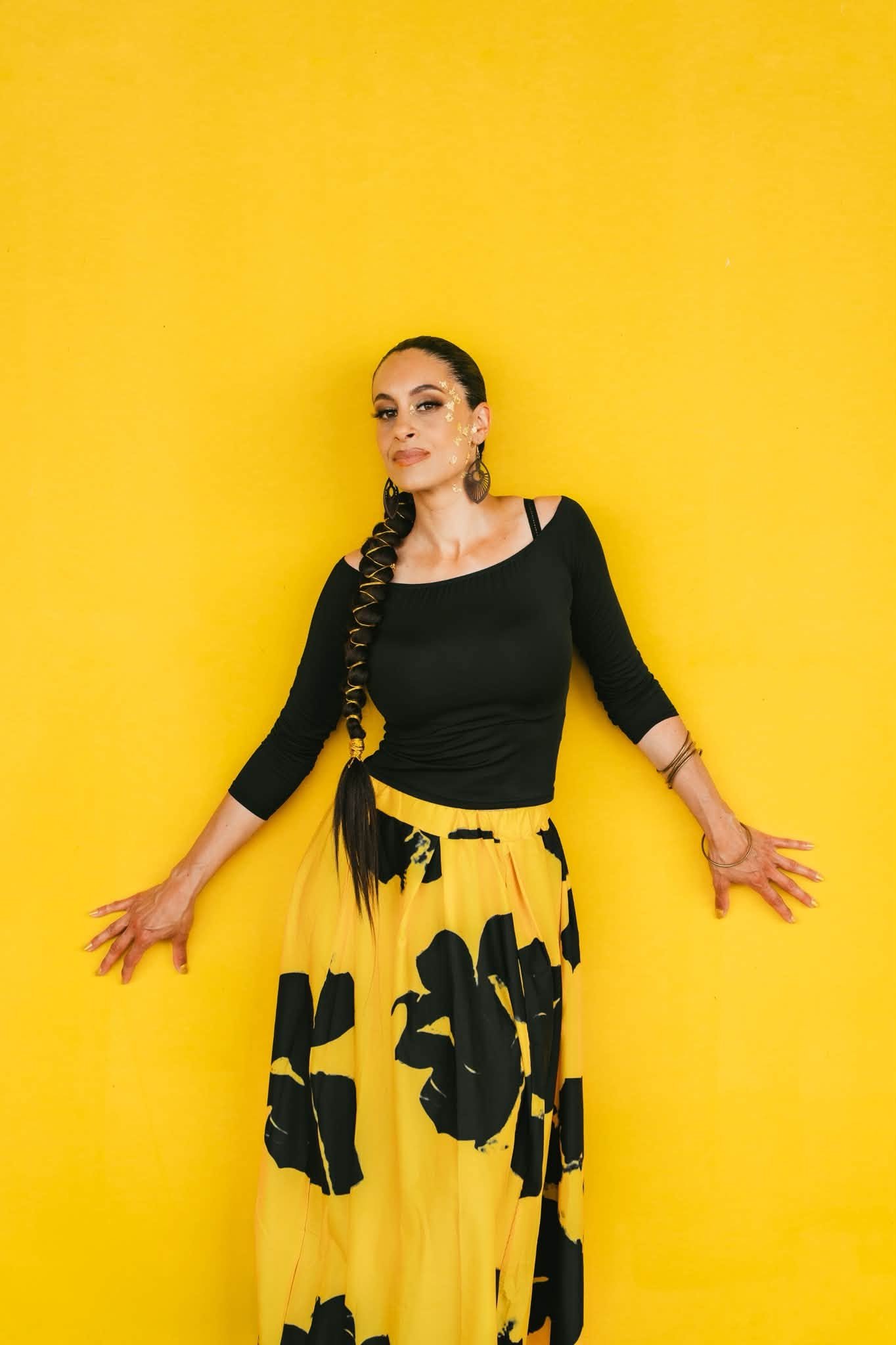 Portrait of Tiffany P. against a yellow background